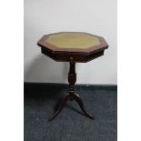 A leather topped occasional table on tripod base