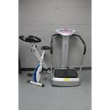 An Marcy vibro plate together with a Davina exercise bike