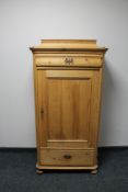 A nineteenth century pine side cabinet fitted with a drawer