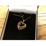 A yellow gold ruby and diamond set heart pendant
