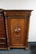 A nineteenth century carved oak side cabinet