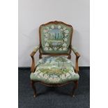 An antique style carved walnut armchair in tapestry fabric