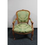 A Continental carved walnut armchair in green fabric