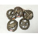 Five East German badges