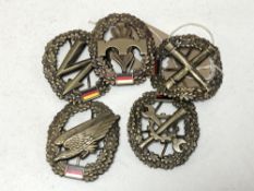 Five East German badges