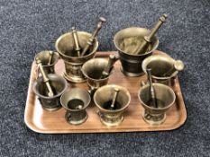 A tray of nine brass pestle and mortars