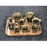 A tray of nine brass pestle and mortars