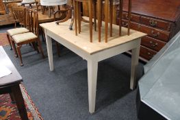 A pine farmhouse table with painted legs