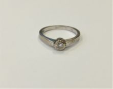 An 18ct white gold solitaire diamond ring, the brilliant cut stone weighing an estimated at 0.