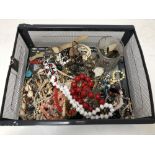 A basket of various costume jewellery, beads, necklaces,