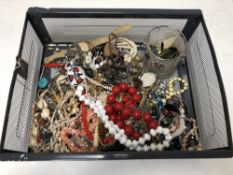 A basket of various costume jewellery, beads, necklaces,