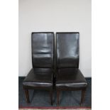 A pair of brown leather dining chairs