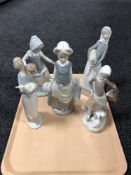 A Lladro figure of a girl carrying milk churns together with four other Spanish figures.