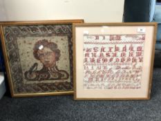 A framed alphabet sampler together with another embroidery