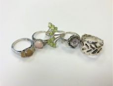 Five silver dress rings.