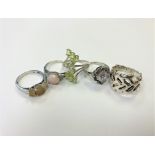 Five silver dress rings.