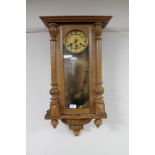 A continental oak cased eight day wall clock