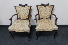 A pair of Edwardian mahogany armchairs