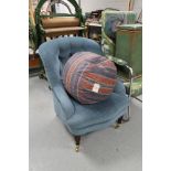 A Victorian style blue buttoned chair together with a footstool