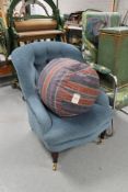 A Victorian style blue buttoned chair together with a footstool