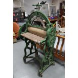 An antique metal cast mangle