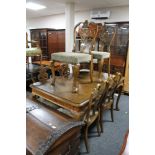 A continental carved oak dining room table on cabriole legs together with a set of six dining room