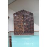 A carved wooden wall cabinet