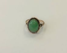A gold and jade ring, size N1/2. CONDITION REPORT: 9ct gold. 4.2g.