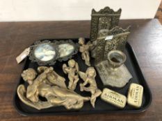 A tray of gilt plaster cherub figures, Player's Airman tobacco tins,