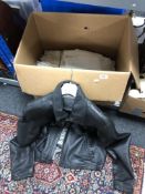 A box of gent's black leather jacket and quantity of twentieth century table linen