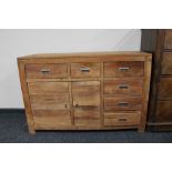 A sheesham wood multi drawer sideboard