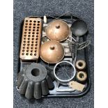A tray of antique metal ware and kitchenalia, jelly mould,