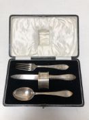 A cased silver knife, fork and spoon, napkin ring.