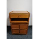 A teak telephone stand fitted with a drawer