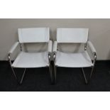 A pair of white stitched leather tubular chairs