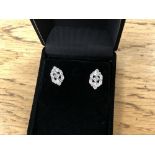 A pair of white gold diamond earrings in antique style