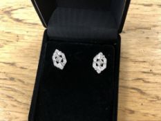 A pair of white gold diamond earrings in antique style