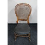 An antique bergere rocking chair
