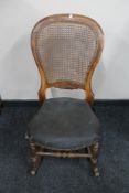 An antique bergere rocking chair