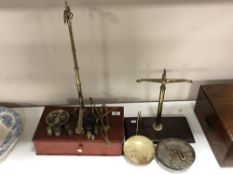 Two part sets of mahogany and brass scales together with a quantity of brass weights