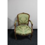 A Continental carved walnut armchair in green fabric