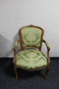 A Continental carved walnut armchair in green fabric