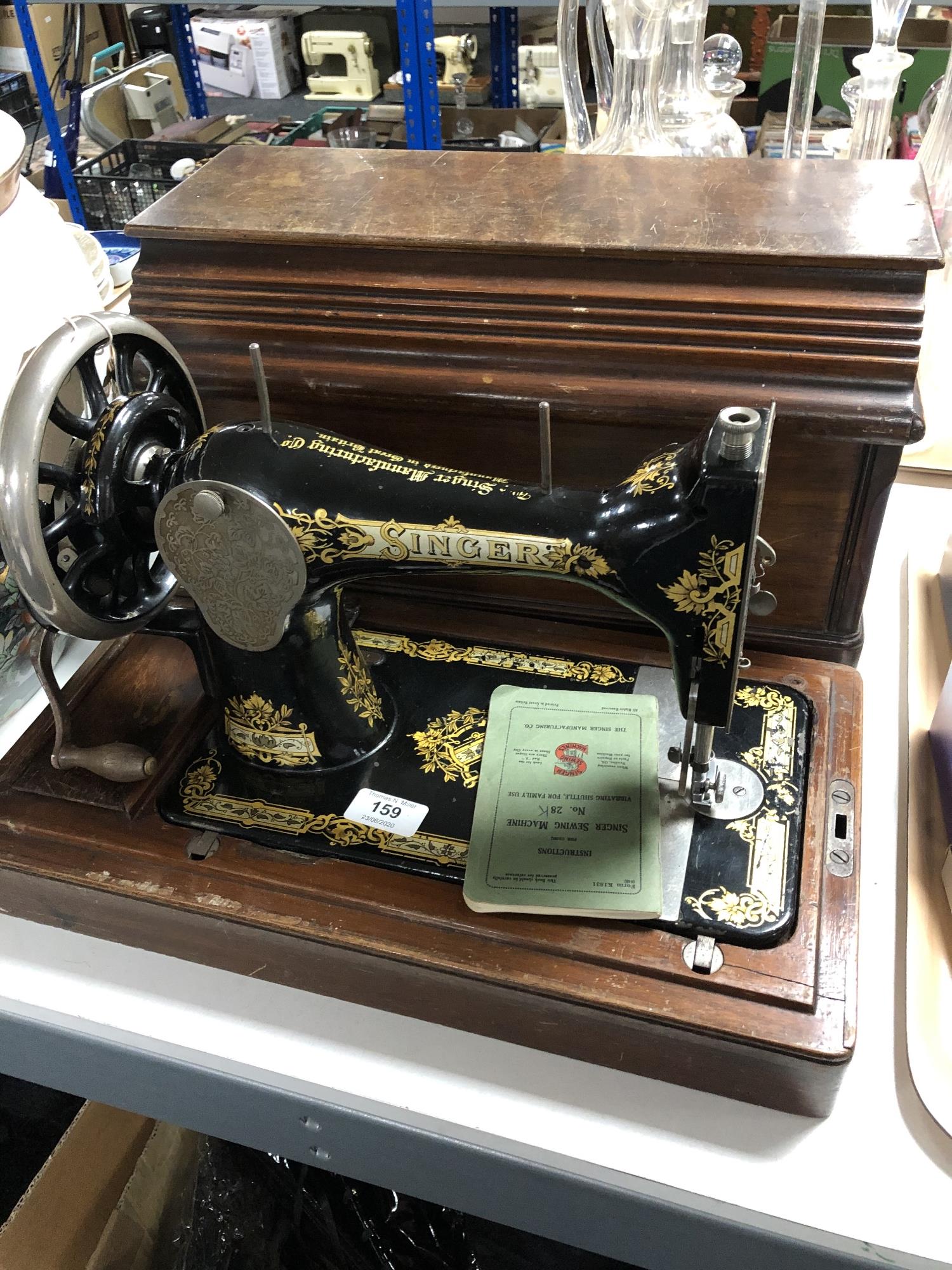 A cased vintage Singer hand sewing machine