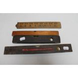 Three vintage spirit levels together with a folding boxwood rule