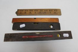 Three vintage spirit levels together with a folding boxwood rule