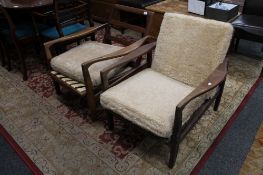 A pair of mid century teak adjustable armchairs