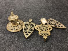 An ornate brass lidded inkwell together with three antique trivets