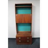 A mid century multi section teak display unit with brass handles