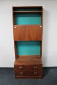 A mid century multi section teak display unit with brass handles