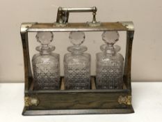 An Edwardian oak and silver plate mounted three bottle Tantalus CONDITION REPORT: